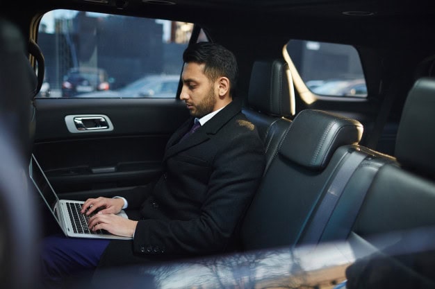 Professional black car corporate transportation service arriving at Atlanta business district