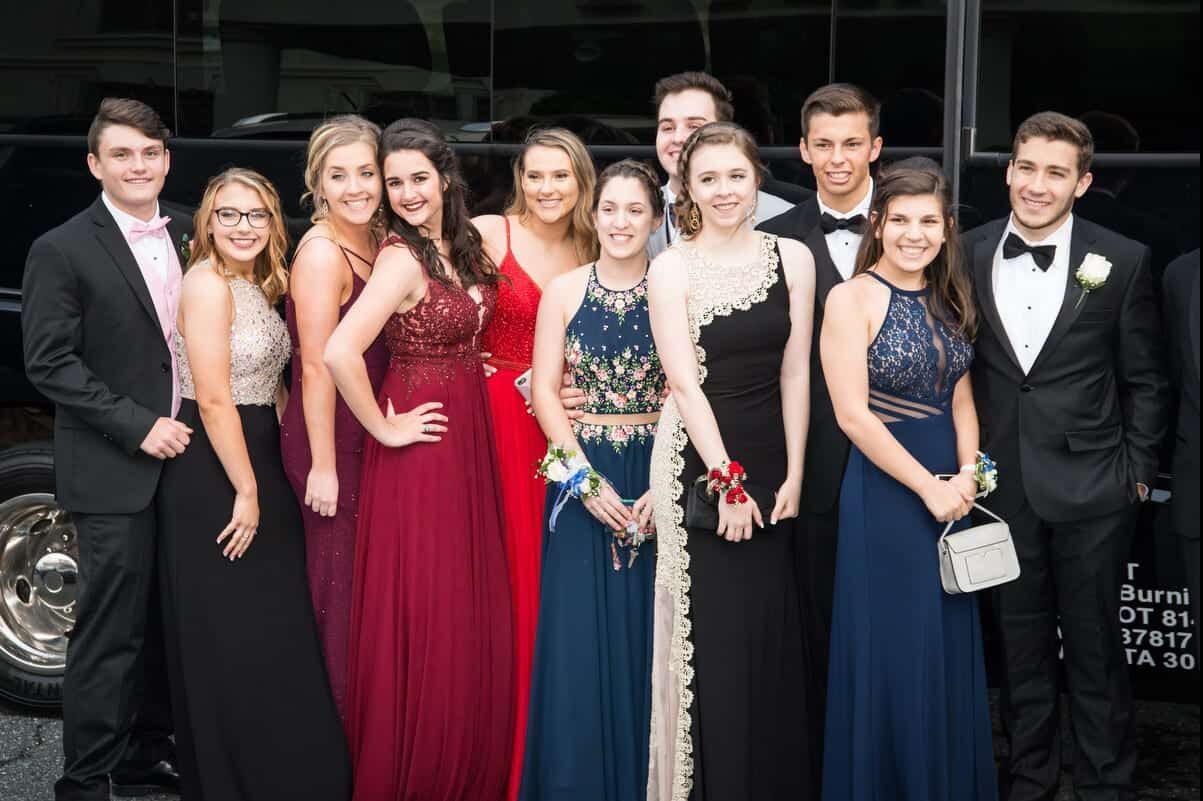 Luxury black limousine arriving at Atlanta high school prom venue for students